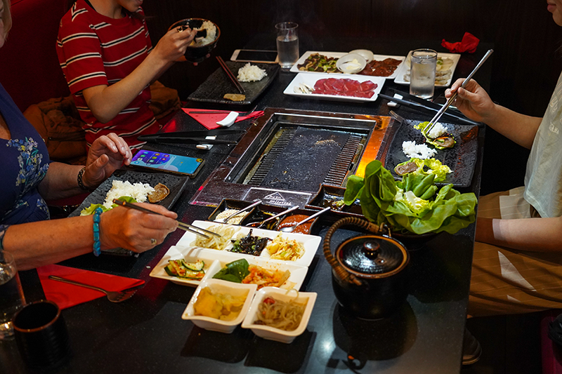 A bunch of friends eating at Mommy Thai fulfilling their winter cravings